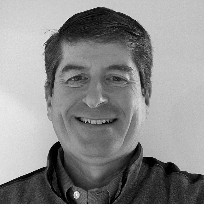 A black and white close up photo of John McGuigan, Vice President at Aquilance